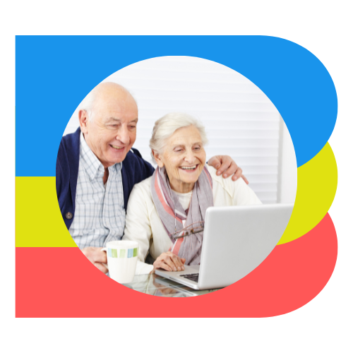 a man with his arm around a woman. both senior-aged. both looking at a computer, smiling.