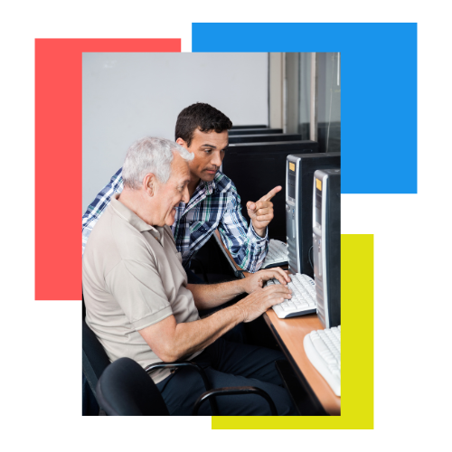 picture of a middle-age main teaching a senior-aged man something on a computer